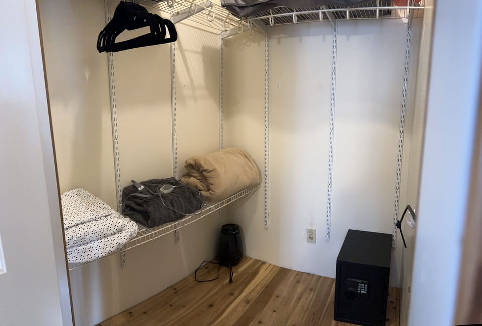 Main bedroom walk in closet with safe 