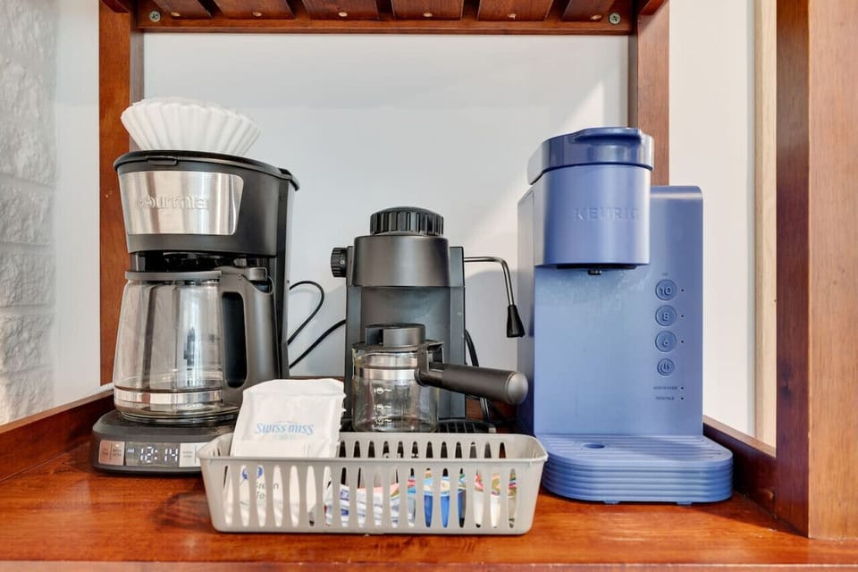 **Kitchen** Enjoy your morning coffee from our convenient coffee station, surrounded by the warmth and character of our oak ceiling beam and mounted oars. Our kitchen with ample seating for 10 on the dining table and island.