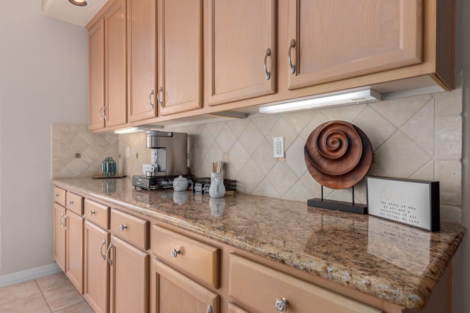 Fully stocked coffee bar with Keurig station, sugars, creamers and pods provided