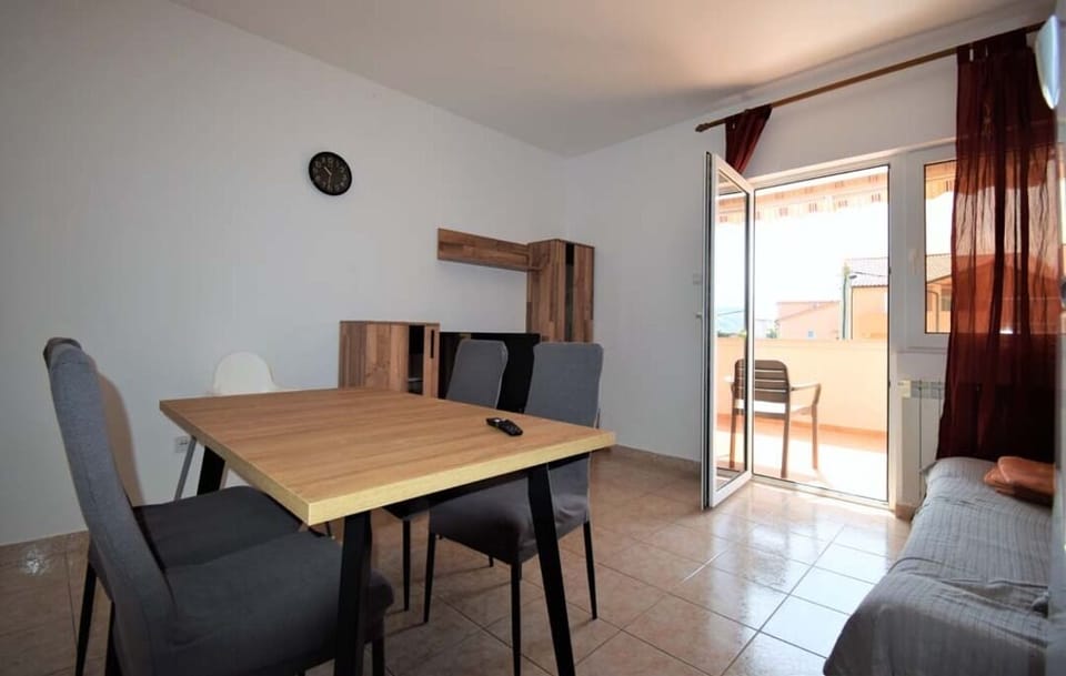 Living room with dining area and natural light.