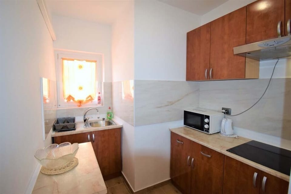 Compact kitchen with cooking essentials.