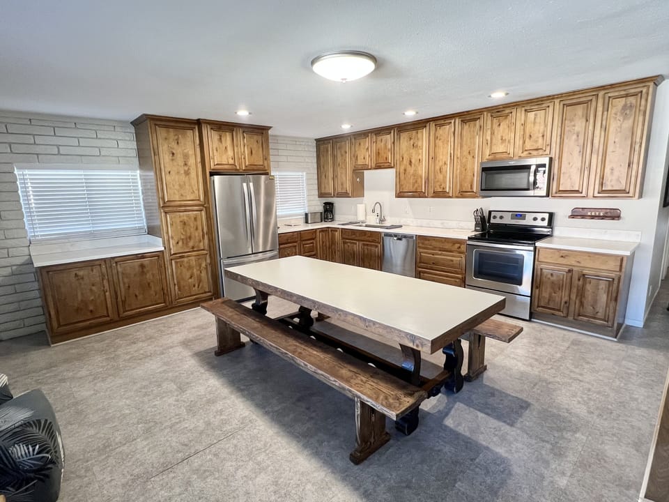 Newly renovated kitchen with family style dining table and plenty of storage.