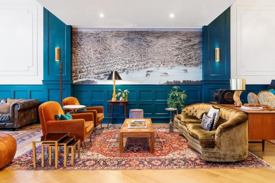 Unwind on velvet seating beneath bold, artful walls.