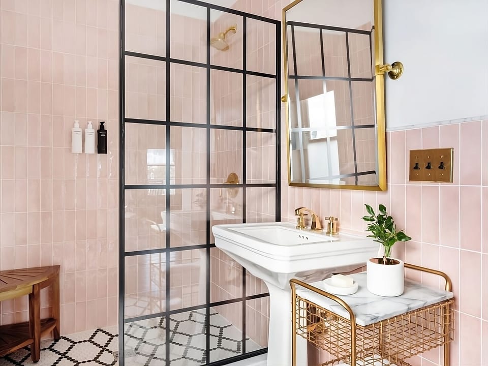 Indulge in a spa-like bath with striking glass partition.
