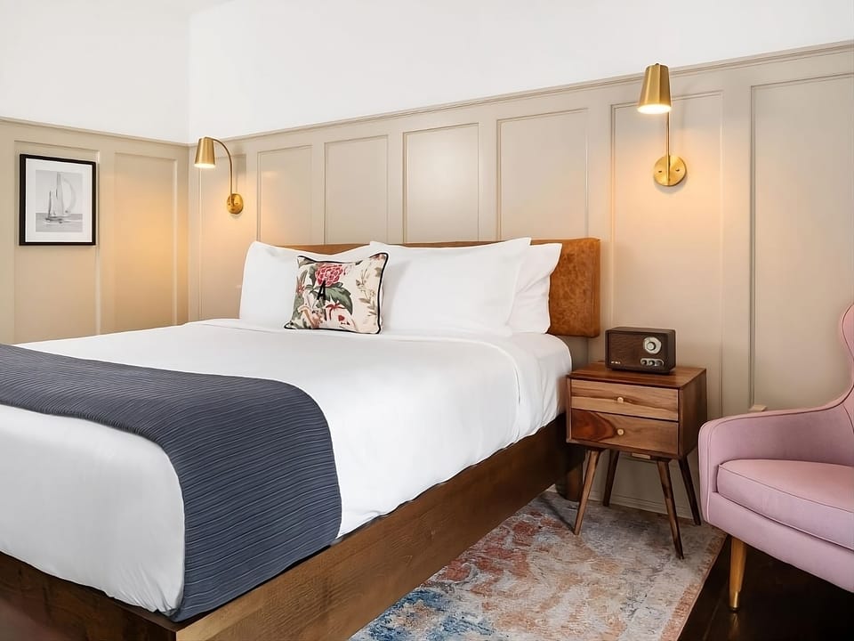 Stretch out on a plush bed in a softly lit retreat.