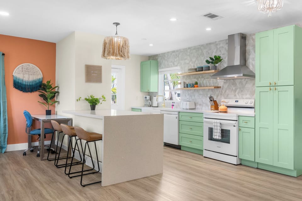 Fully equipped kitchen with everything you need to cook fresh meals by the sea. The dining table even converts into a pool and ping pong table for added fun.