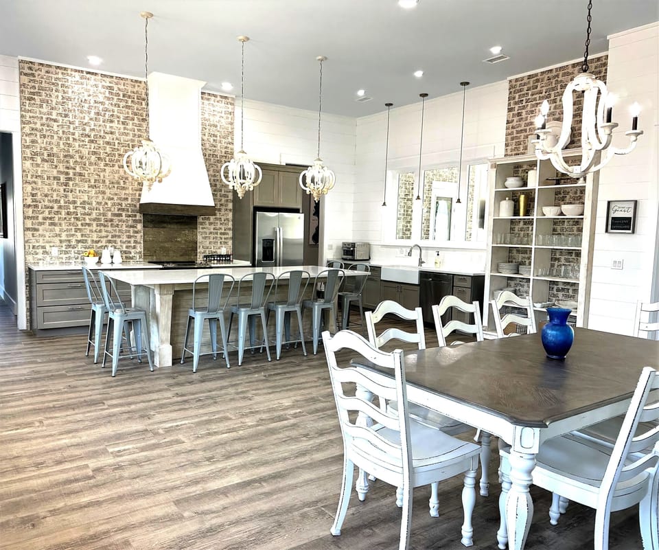 Dining for 18 in one area. Custom built dish shelf unit, range hood, 10' island
