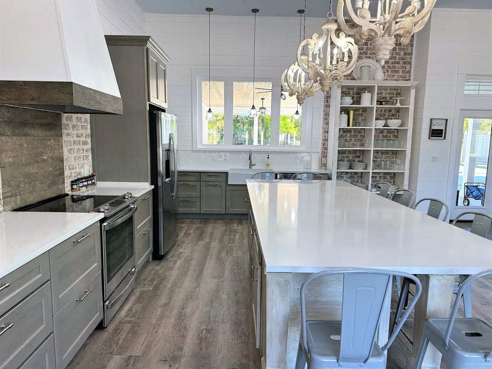 Loads of counter space, farmhouse sink, microwave in island, window to patio