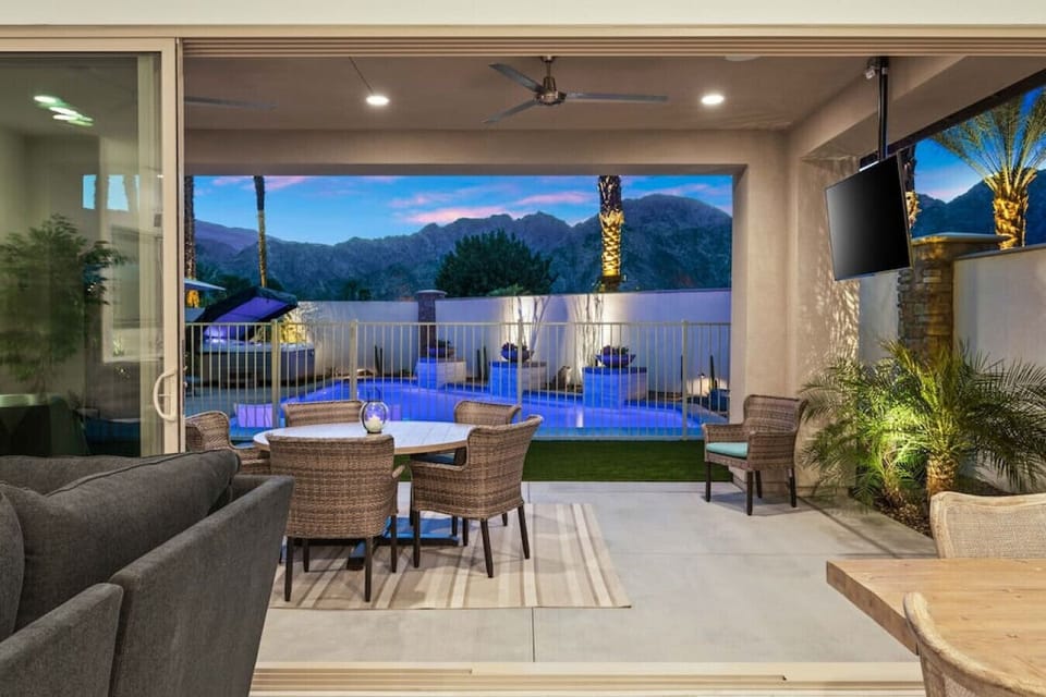 Covered patio w/ dining, TV & pool views for seamless indoor-outdoor living