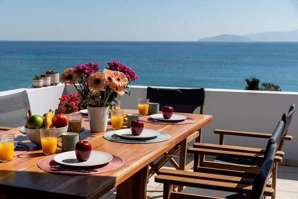 "Seaside Dining: Unwind at Our Balcony Table with Panoramic Ocean Views"