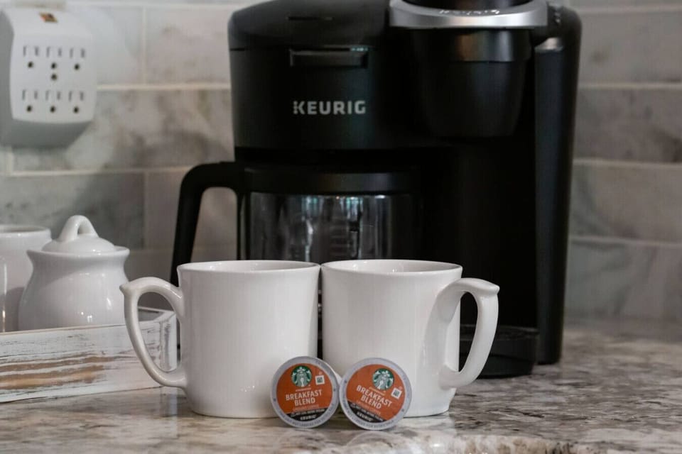 Start your mornings right with a dedicated coffee station featuring a Keurig, mugs, and everything you need for a relaxed lakeside wake-up.
