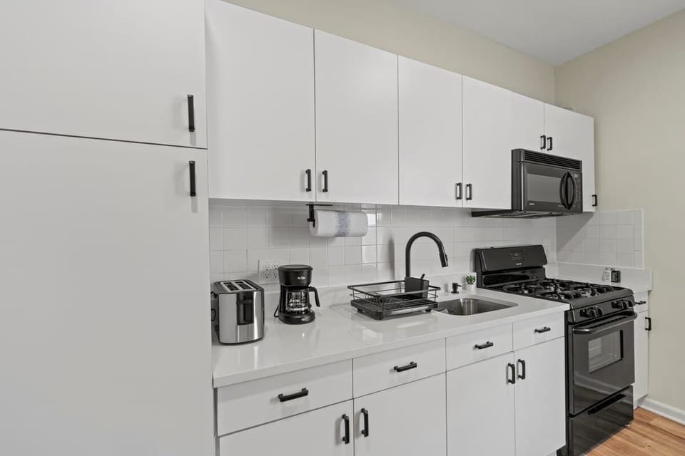 Fully equipped kitchen featuring modern appliances, cookware, a breakfast table for extra guests, and everything you need to prepare meals for your family or group.