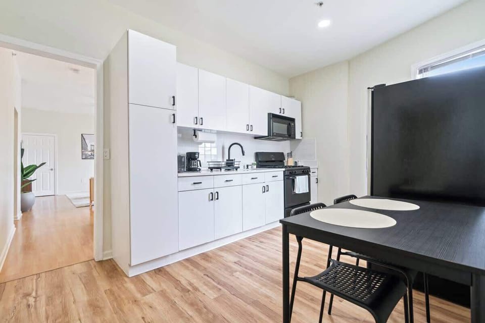 Fully equipped kitchen featuring modern appliances, cookware, a breakfast table for extra guests, and everything you need to prepare meals for your family or group.