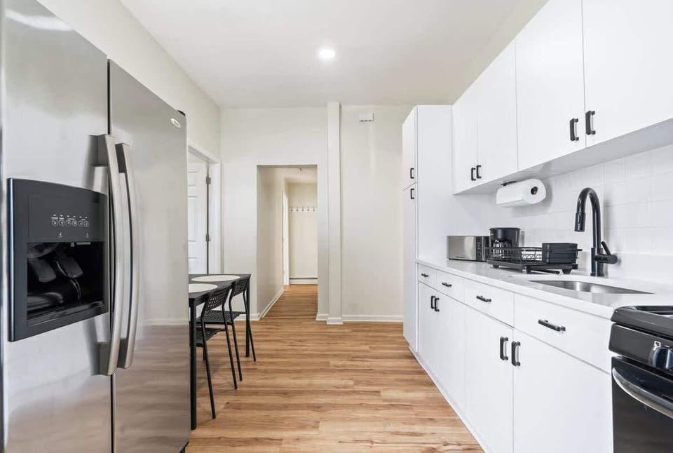 Fully equipped kitchen featuring modern appliances, cookware, a breakfast table for extra guests, and everything you need to prepare meals for your family or group.