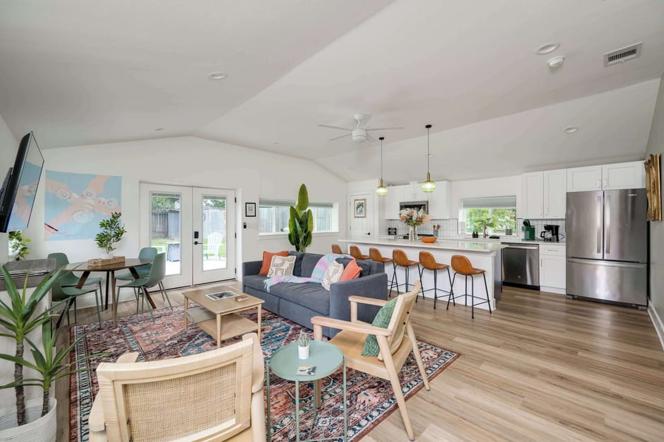 Stocked with basics: Cooking kitchen with large entertainment island with bar seating. Opens to living area. 