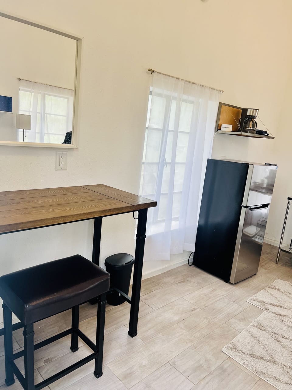 Kitchenette with mini refrigerator and bar space to eat.  