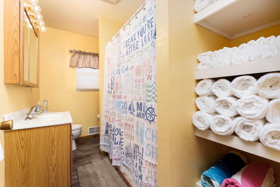 [Full Bathroom] Plenty of beach towels for your family are located here.