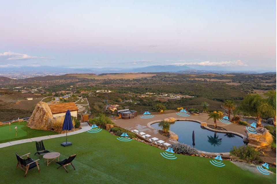 Poolside entertaining is elevated with a Sonance Garden Series outdoor music system featuring 9 Bluetooth-connected speakers.