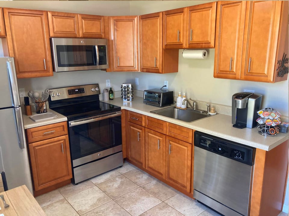Full kitchen equipped with coffee maker, toaser oven, and microwave.