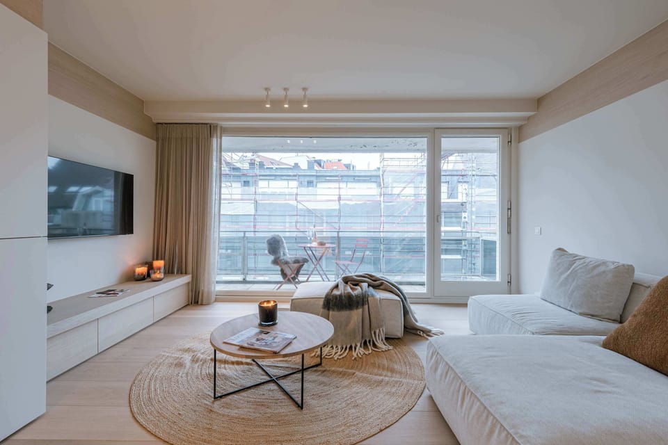 Relax in this bright, modern living room with a cozy sofa, stylish decor, and a peaceful view. Perfect for unwinding after a day of adventure or enjoying a quiet evening in.