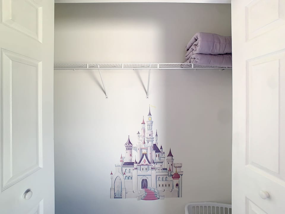 Playful kids’ closet with magical wall art for a whimsical touch.