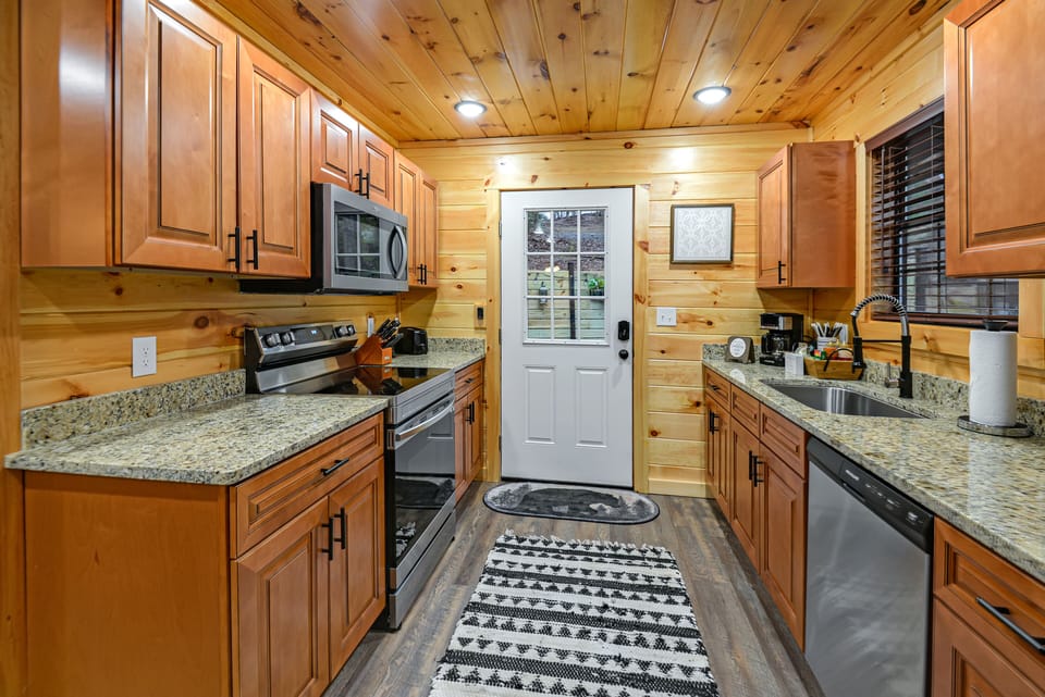 Full kitchen w/ granite counter tops and stainless-steel appliances. 