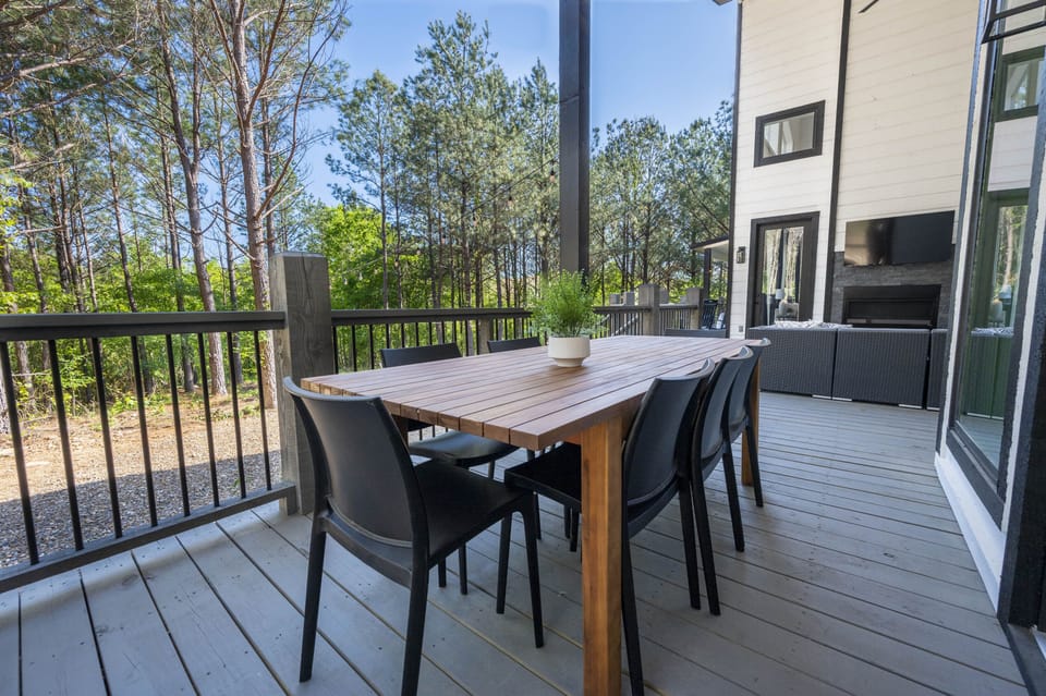 Covered outdoor dining surrounded by peaceful views of the forest.