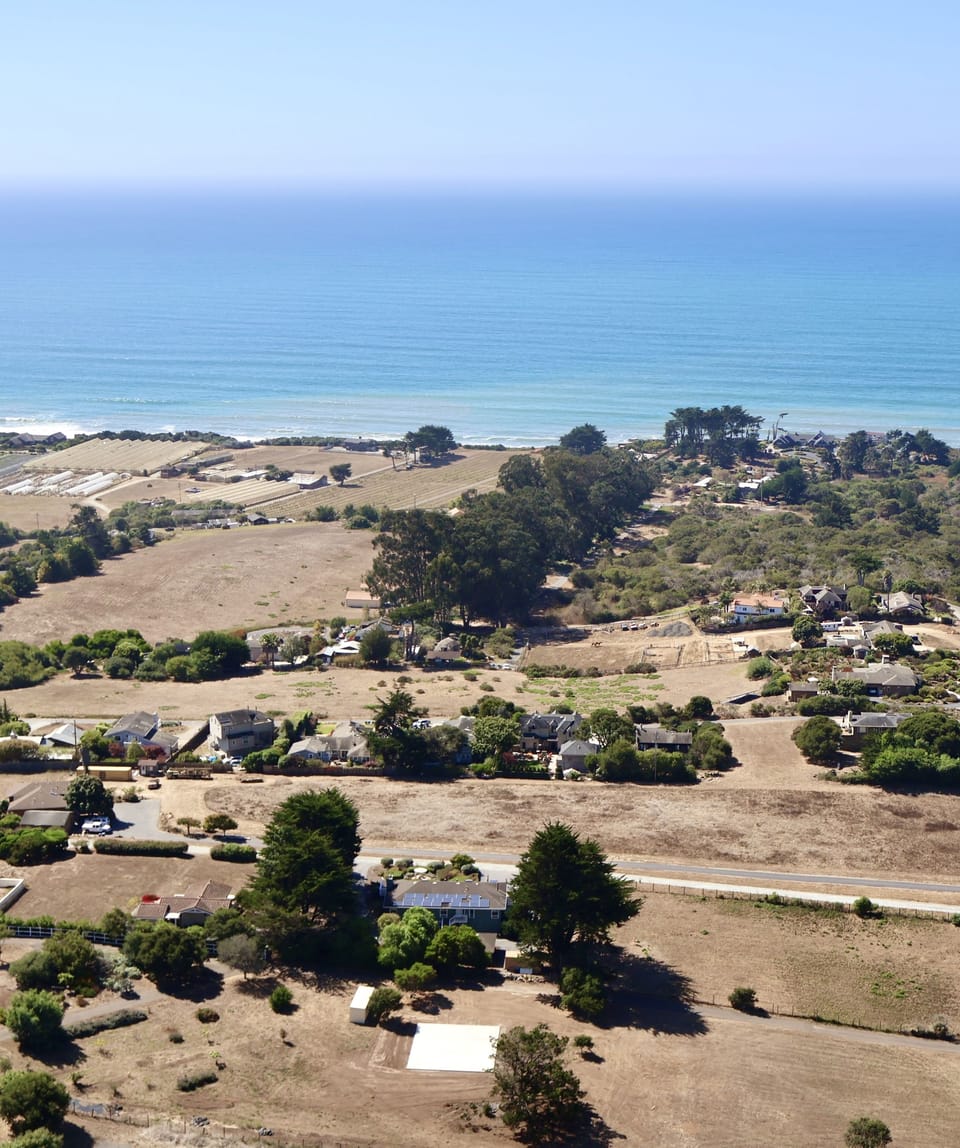 House in the foreground with ocean views. 