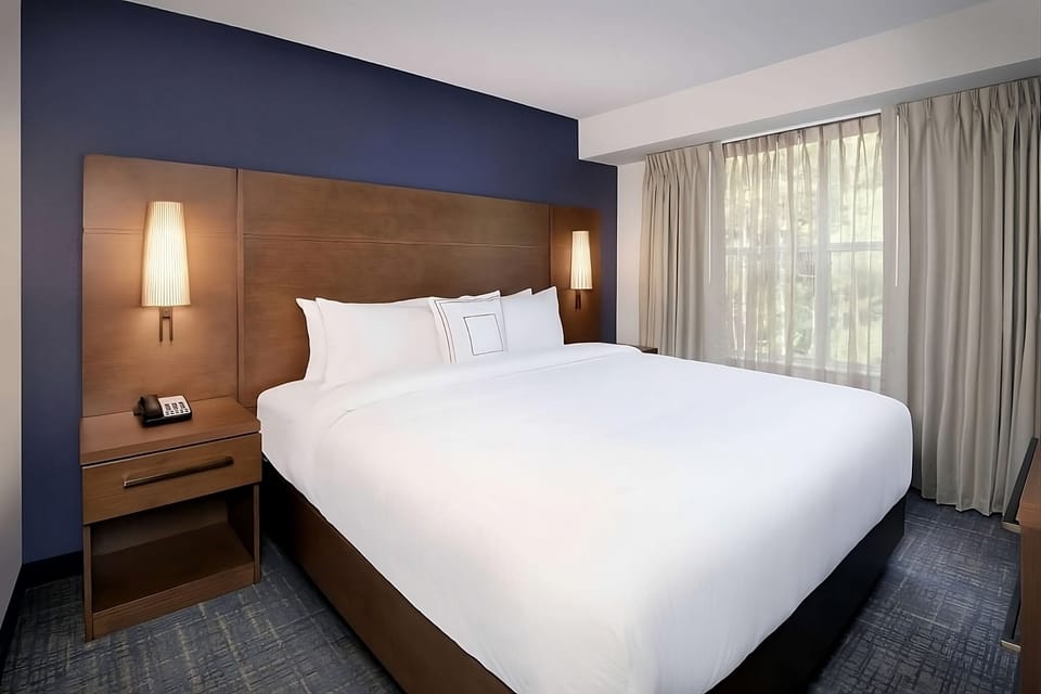 Drift off comfortably with soft lighting and blackout curtains nearby.