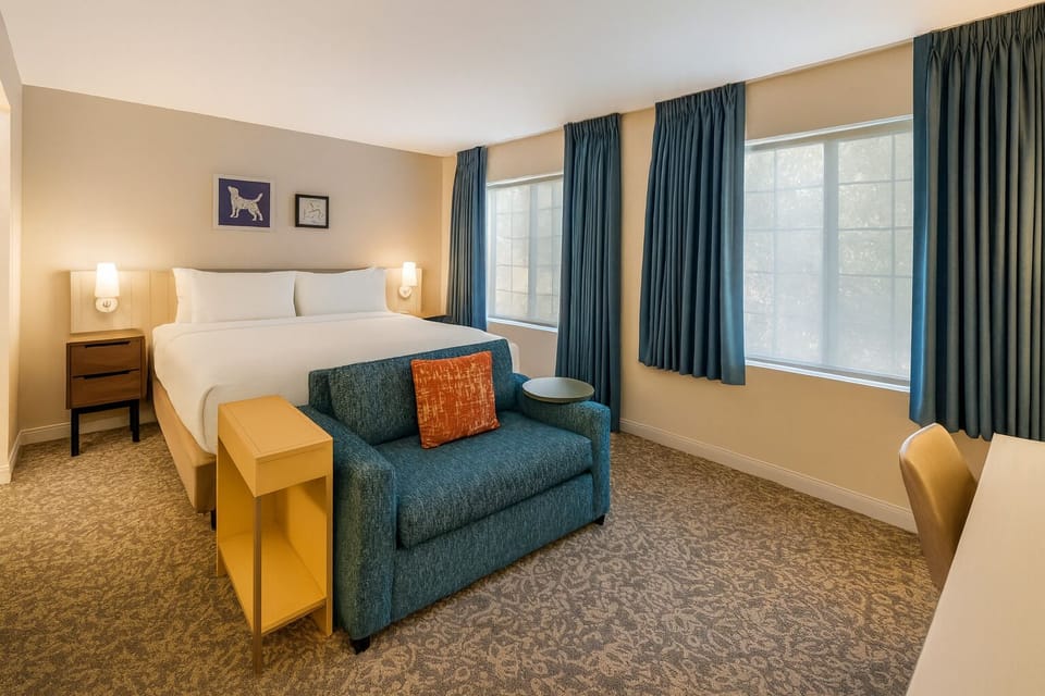 Unwind in a sunlit bedroom with plush linens and calm vibes.