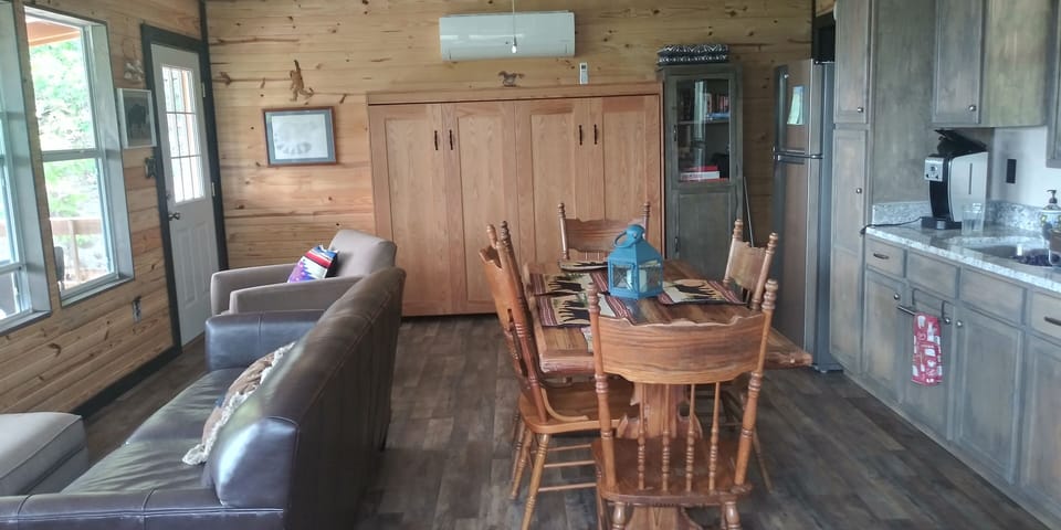 Top floor is open space with kitchen, living, queen Murphy Bed, and bathroom