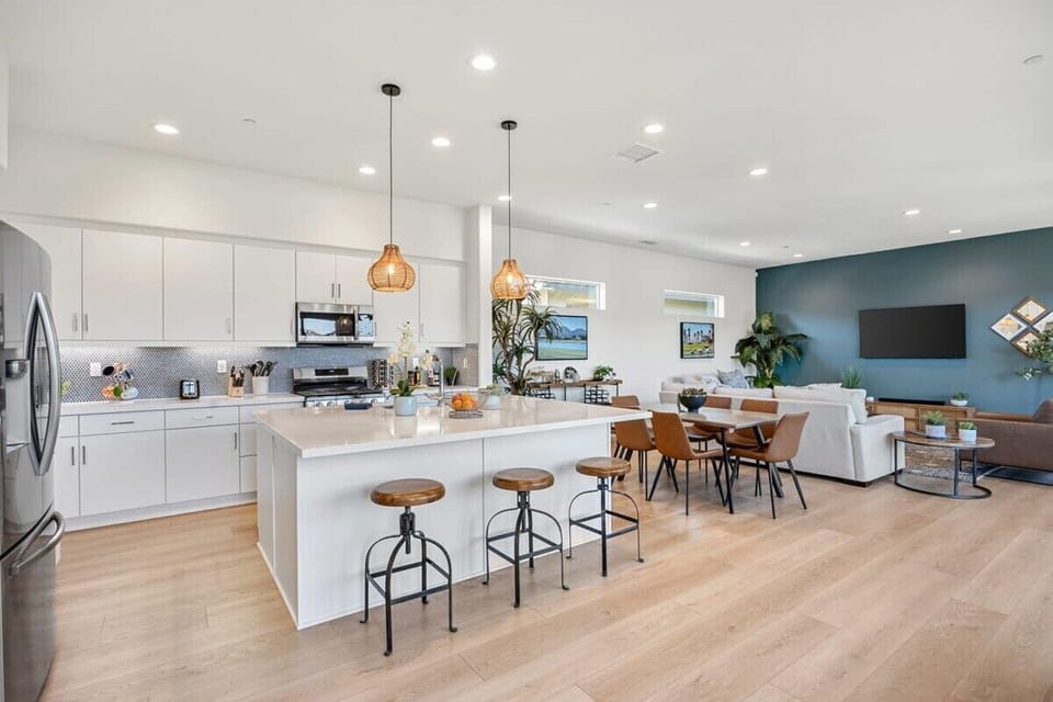White cabinets and waterfall island shine.