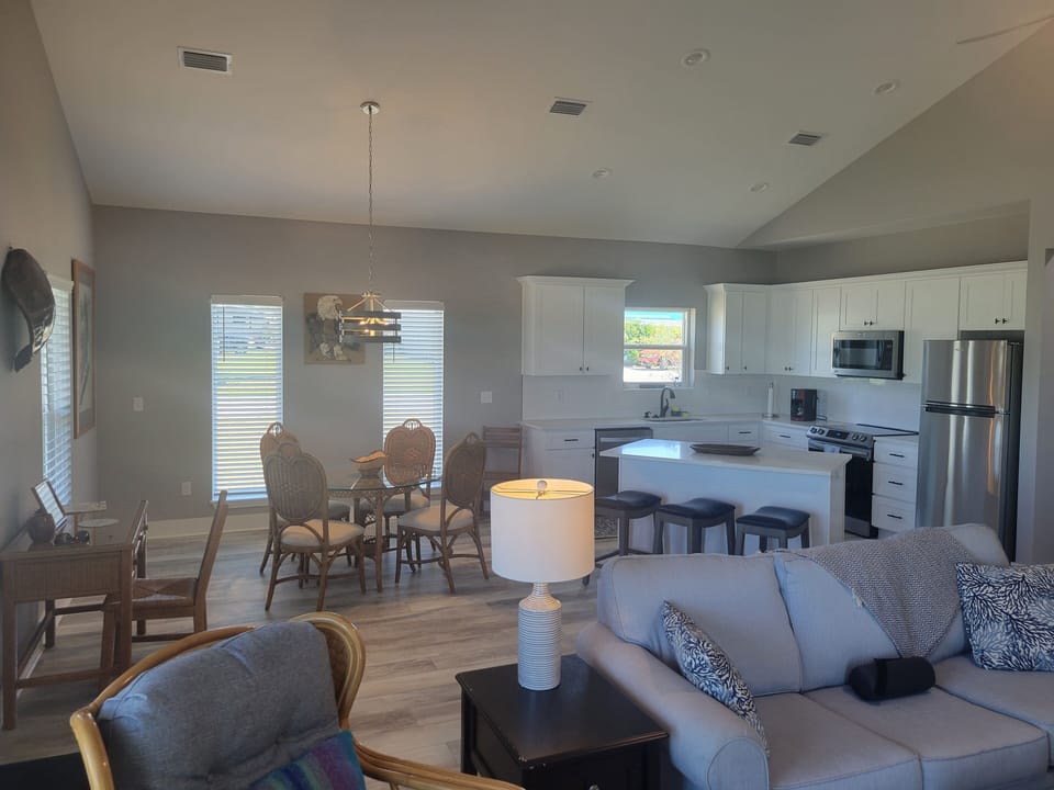 Large living area with dining table and bar area.