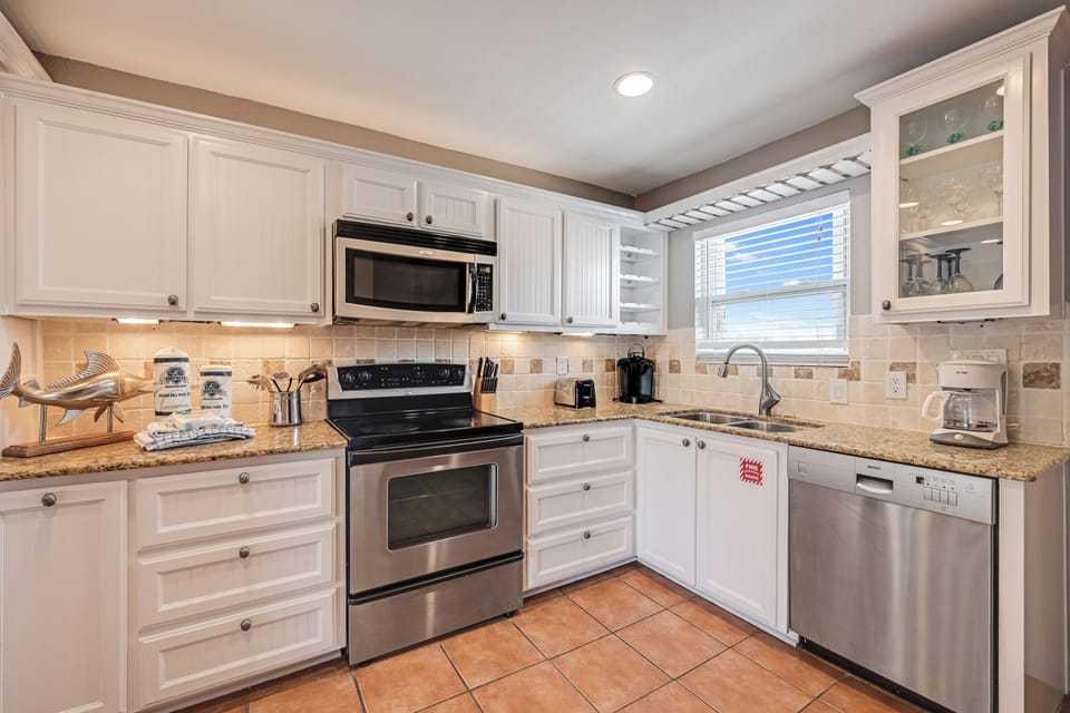 Your fully equipped kitchen awaits with granite counters, stainless appliances, and everything you need to create delicious meals during your stay.