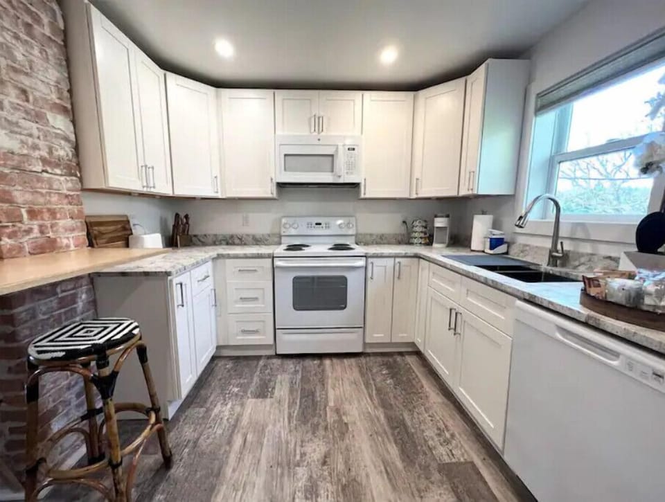 The kitchen features granite counters and is equipped for short & extended stays