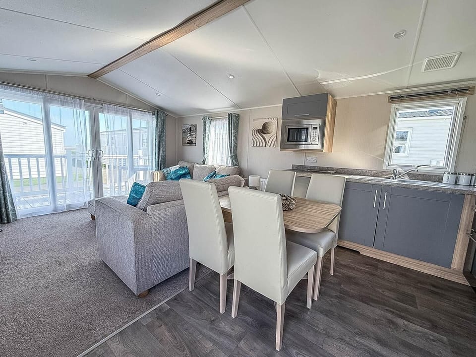 Plan your next British staycations at Broadland Sands Holiday Park Lowestoft, a top destination for caravan holidays Suffolk with stunning views of the Suffolk coast and a cosy kitchen area in a caravan.