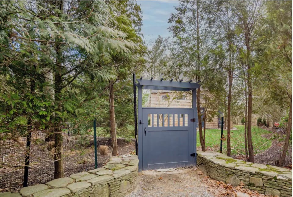 Gate leads to private grassy yard