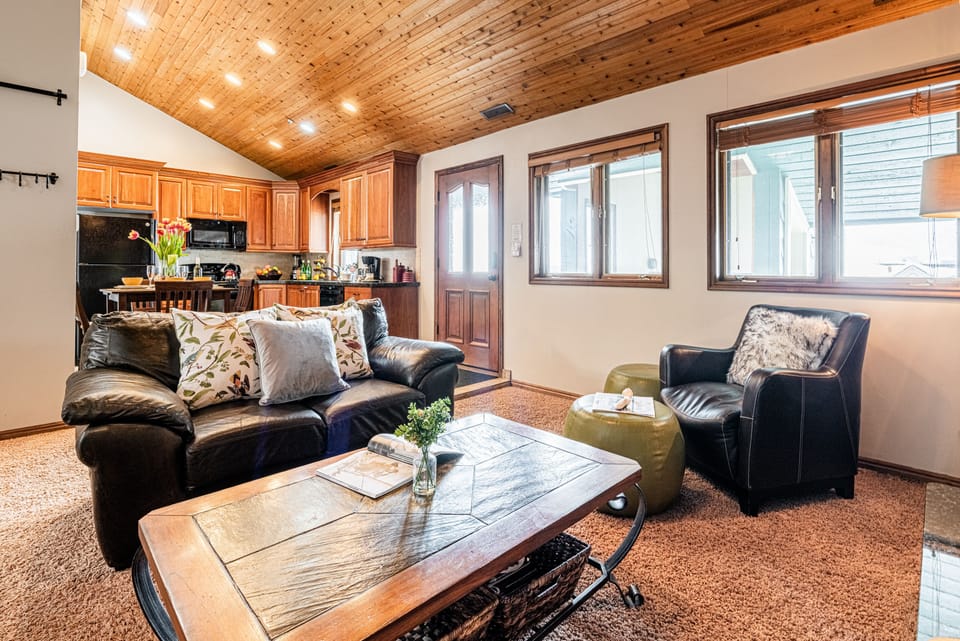 Living Room with leather couches, gas fireplace, smart TV & work desk