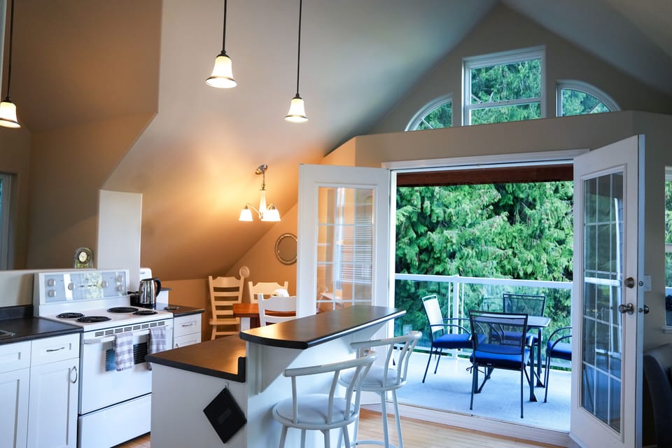 Kitchen with French doors to balcony. Enjoy your morning here on sunny days.