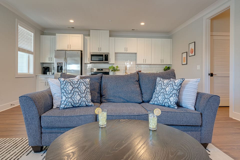 Modern Living Space featuring designer furnishings and a flat-screen SMART TV overlooking the fully equipped kitchen.