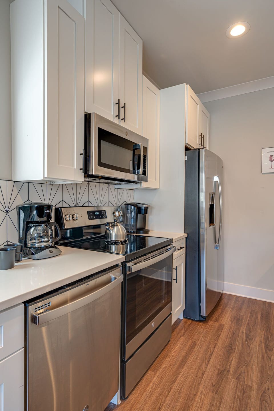 Fully Equipped Kitchen stocked with basic cooking essentials and stainless-steel appliances.