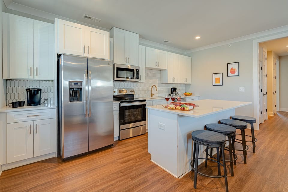 Bright open kitchen stocked with your basic cooking essentials. Complete with stainless steel appliances and breakfast bar seating.