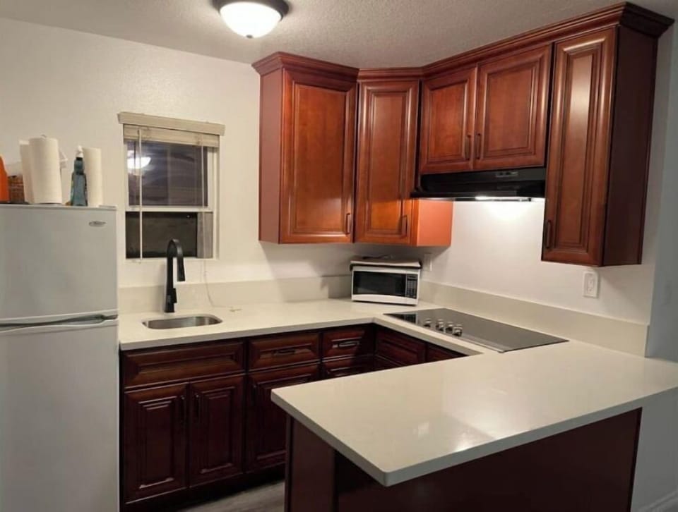 Kitchenette equipped with dishes, silverware, pots and additional staples 