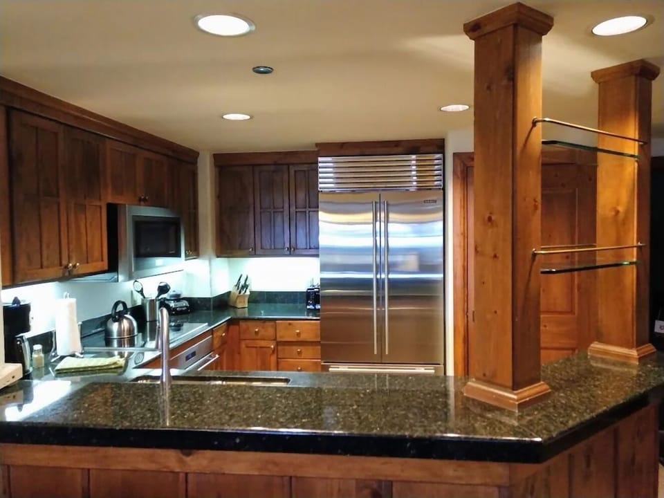 High end kitchen with stainless steel appliances.