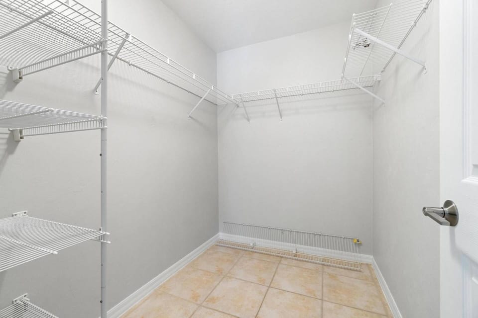 Just outside the primary bathroom is a very large, enclosed walk-in closet with ample storage space for any length of stay.