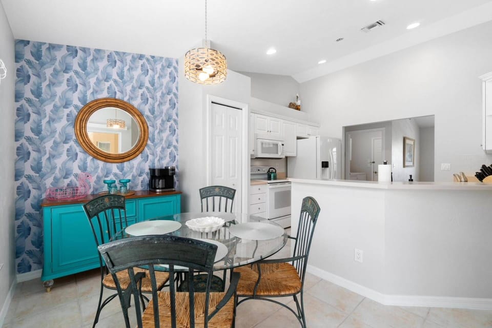 The kitchen is fully equipped and features an adjacent breakfast nook and coffee/cocktail bar with lanai access.