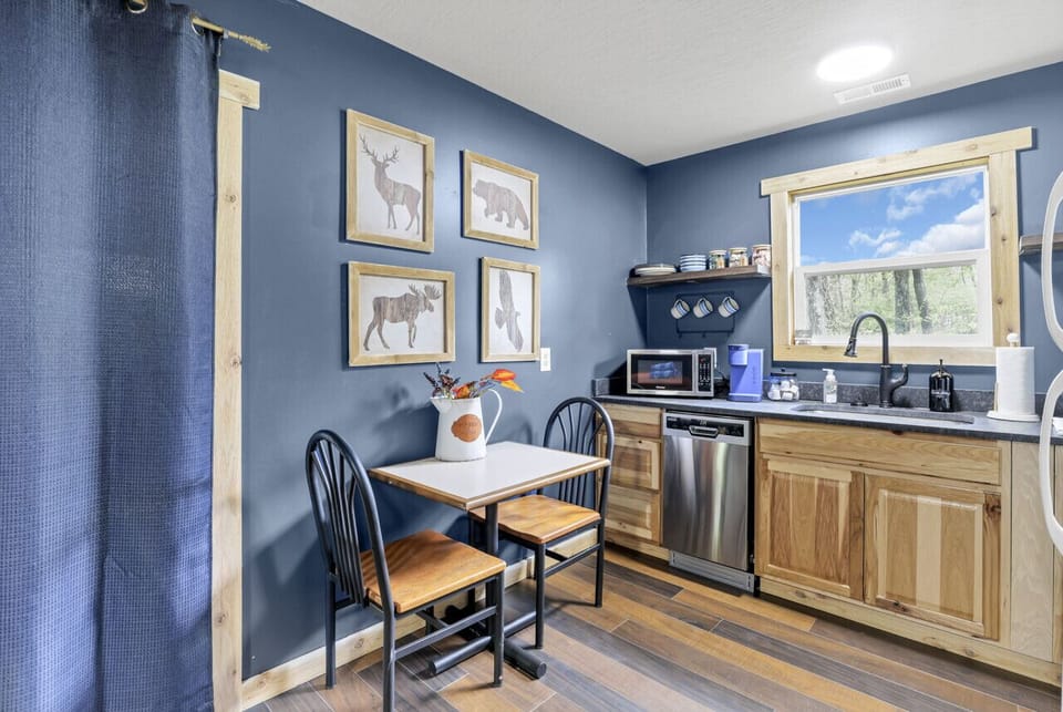 Kitchen table, dishwasher, microwave, coffee maker, and sink
