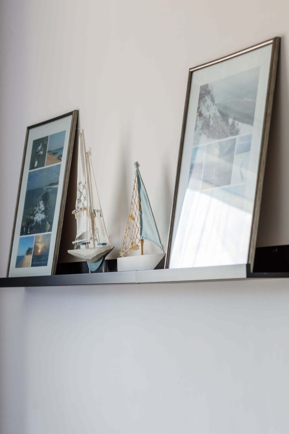 A collection of framed art leaning on a shelf, adding a stylish touch to the room.
