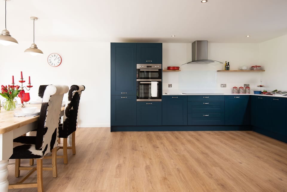 Westwood Cottage - open-plan kitchen/dining space with navy Shaker-style cabinetry