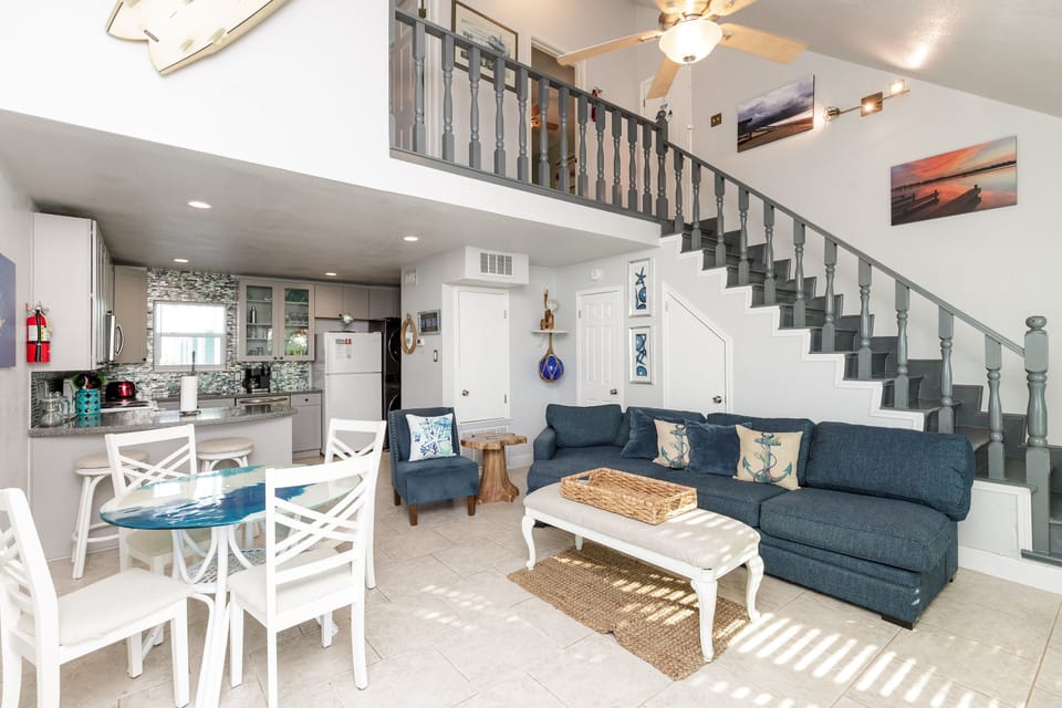 Relax in this bright open-concept space where coastal charm meets comfort. Your living room flows seamlessly into the kitchen, perfect for vacation gatherings.